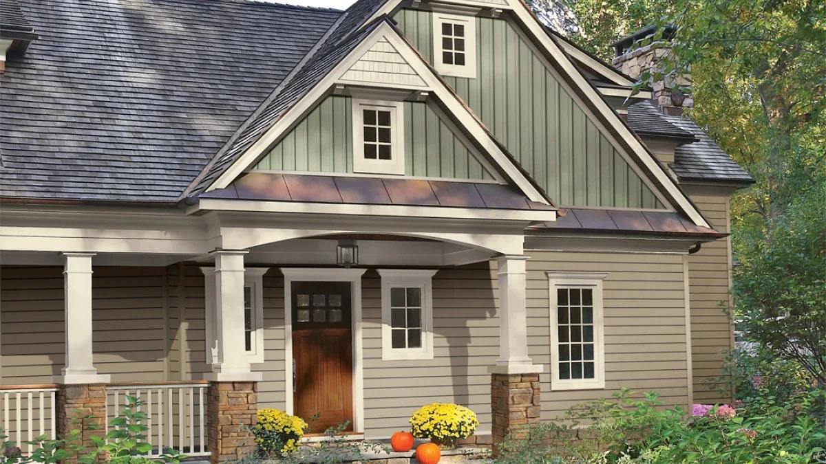 Home combining tan lap siding, green board-and-batten gables, and cream trim